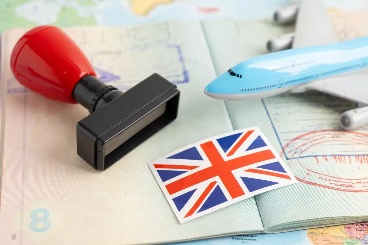 UK flag with approved Stamp visa and passport